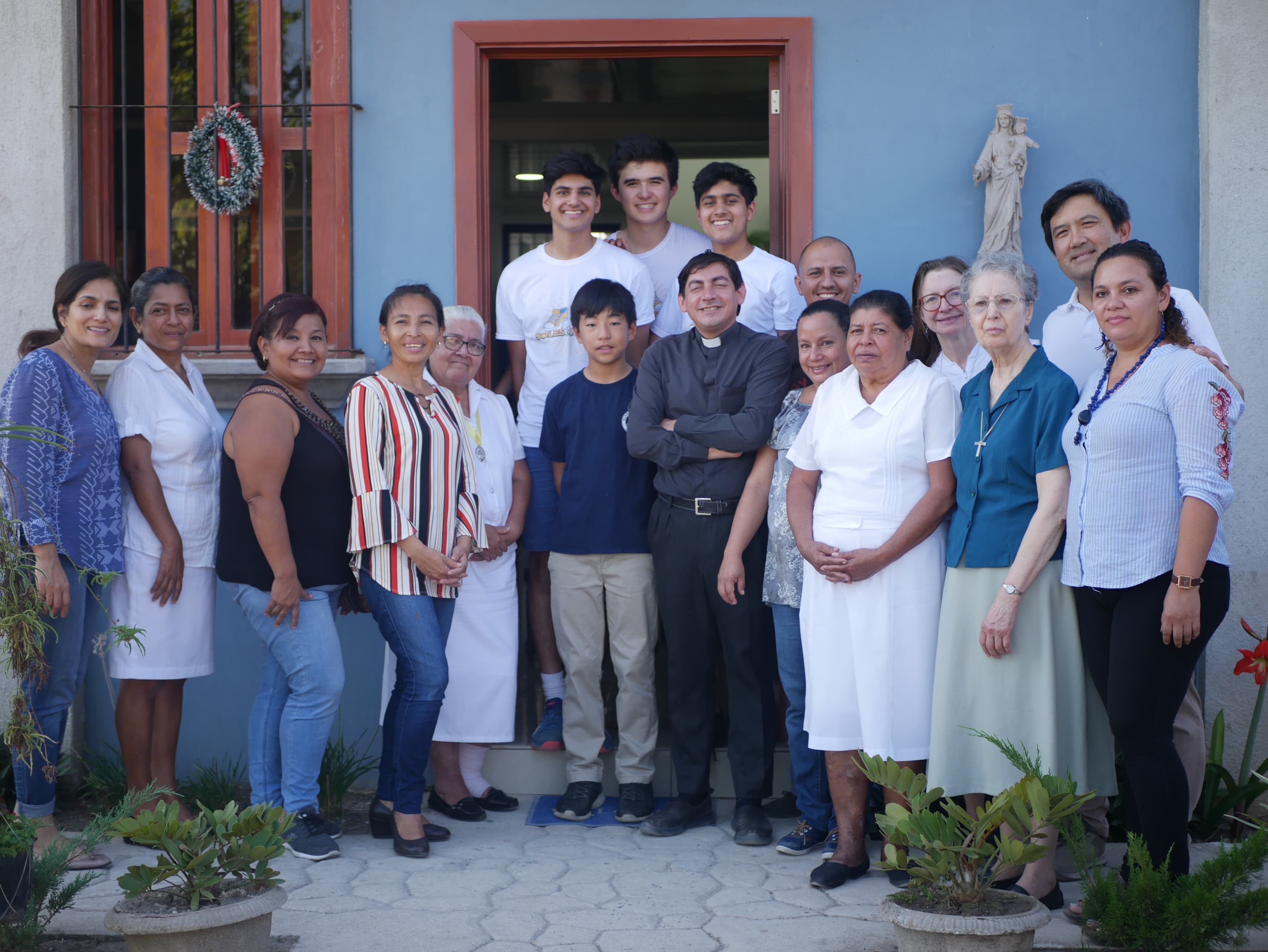 A photo of Amaan, Rowan, and Aariz alongside the women of Soles4Good in our El Salvador mission